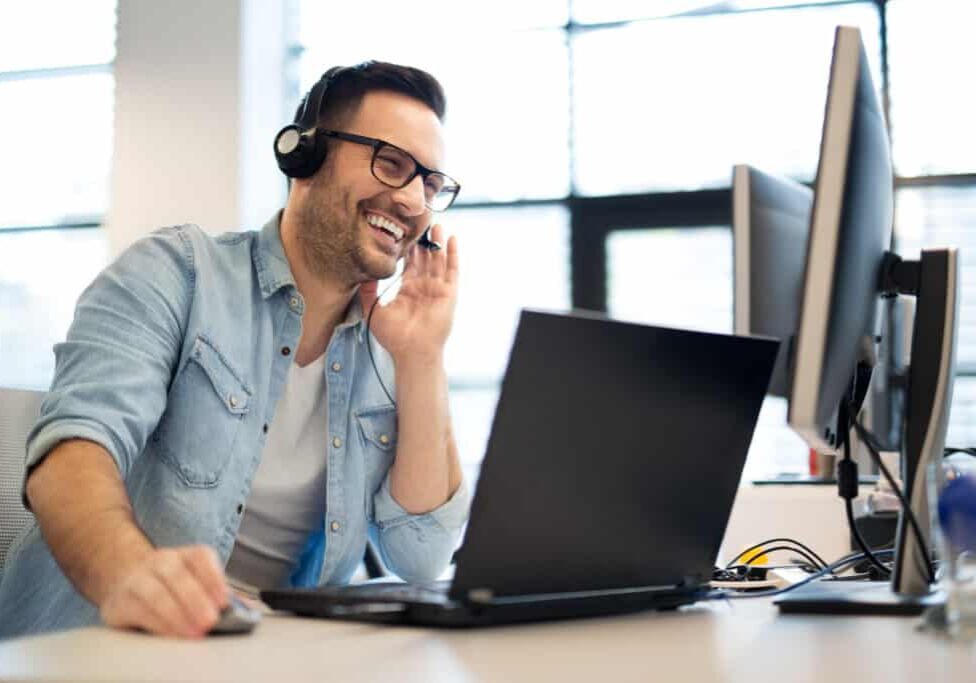 Young smiling male call center operator